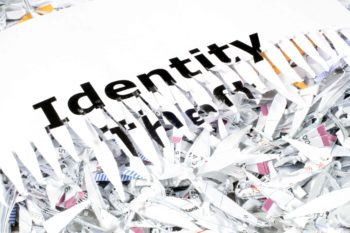 A piece of of shredded paper with the words "identity theft"