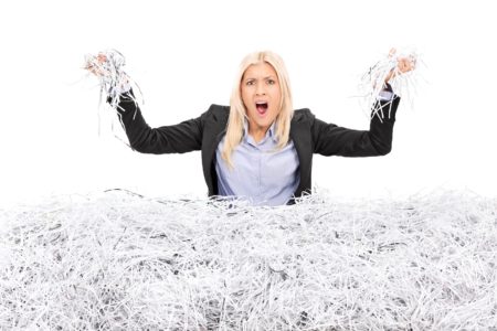 Angry person in a pile of shredded paper